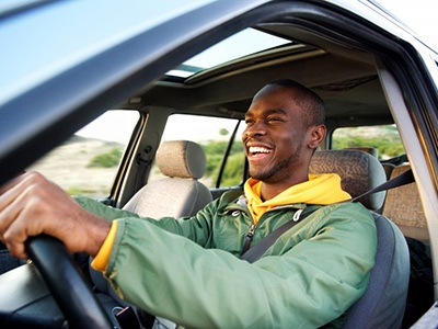 Smiling man drives