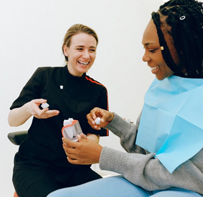 Dentist discussing dental crowns with female patient