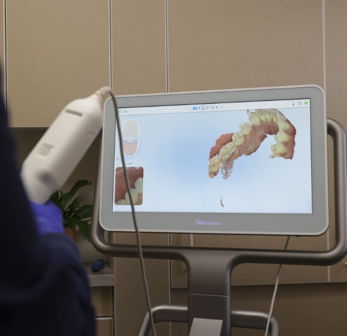 Dental team member using digital impression system