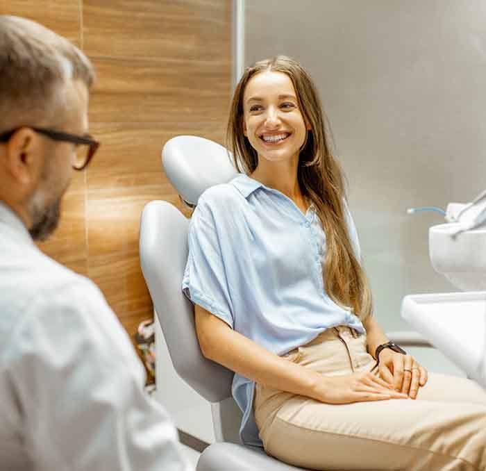 Hand holding dental implant dentures prior to placement