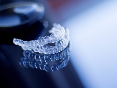 Clear aligners on a dark reflective surface