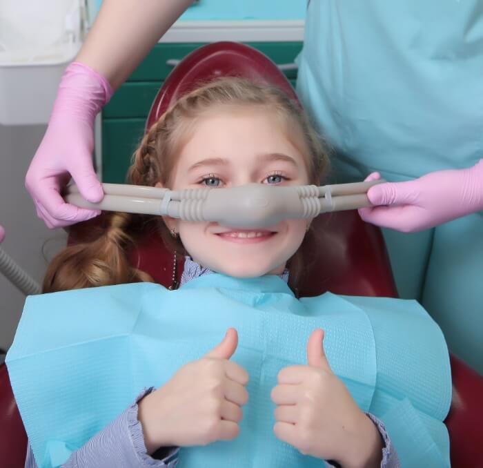 Smiling child receiving nitrous oxide sedation dentistry