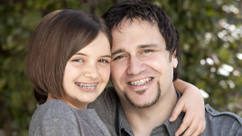 Father and child receiving orthodontic treatment