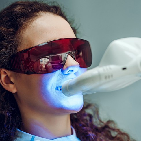 Woman having in-office teeth whitening treatment