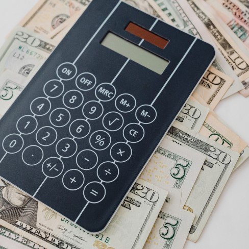 Calculator on stack of cash