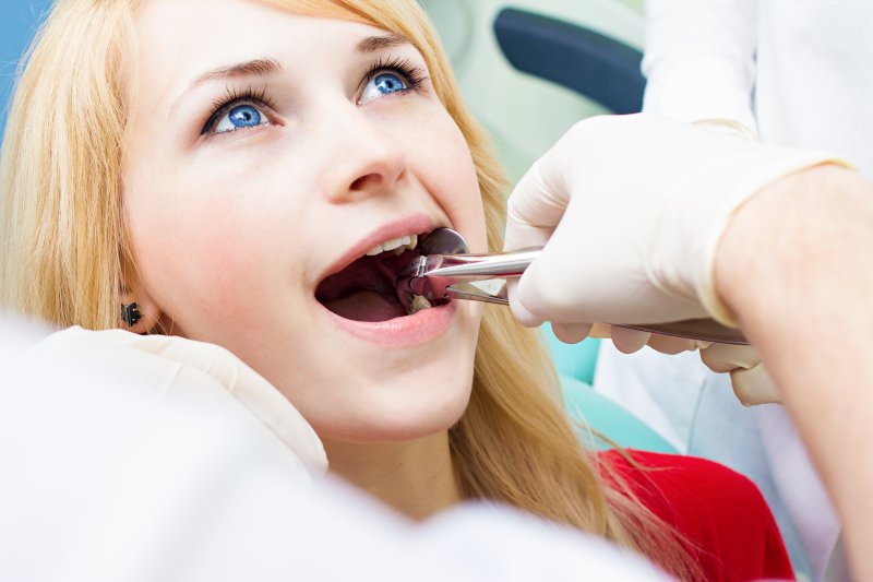 A woman having one of her teeth extracted